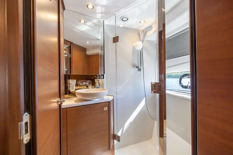Quick Decision Yacht Photos Pics Modern bathroom interior on 2020 Princess V50 yacht with wooden cabinetry and glass shower.