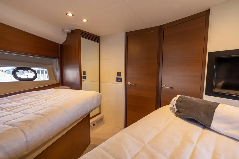 Quick Decision Yacht Photos Pics Luxurious cabin interior of 2020 Princess V50 yacht with twin beds and wooden finishes.