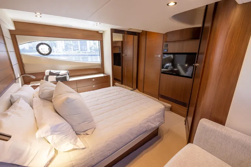 Quick Decision Yacht Photos Pics Luxurious bedroom interior of 2020 Princess V50 yacht with modern furnishings and ample natural light.