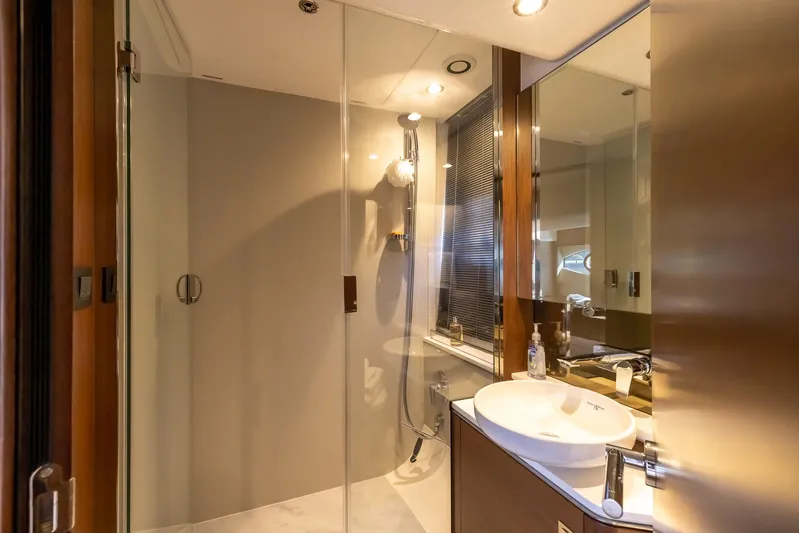 Quick Decision Yacht Photos Pics Modern bathroom on a 2020 Princess V50 yacht with glass shower and sleek fixtures.