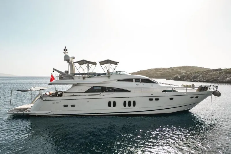  Yacht Photos Pics 2004 FAIRLINE SQUADRON 74 yacht anchored in serene coastal waters.