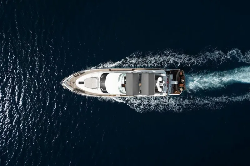  Yacht Photos Pics Aerial view of 2004 FAIRLINE SQUADRON 74 yacht cruising on open water.