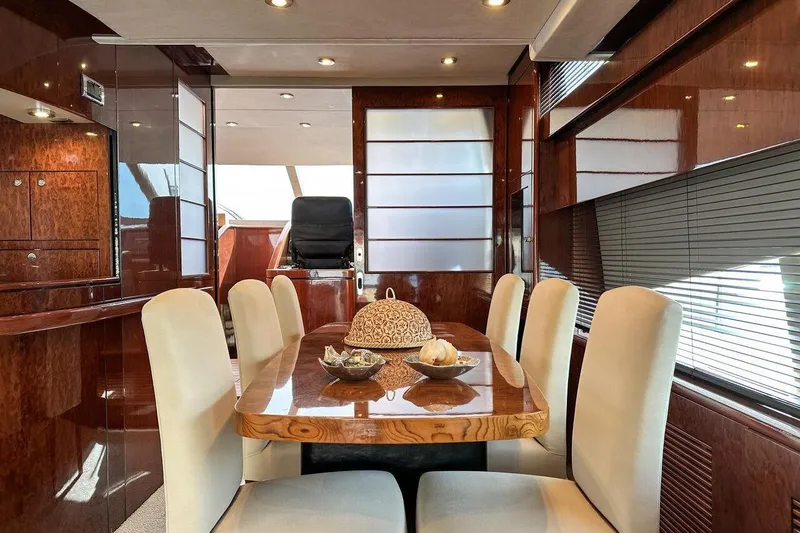  Yacht Photos Pics Luxurious dining area on a 2004 FAIRLINE SQUADRON 74 yacht with elegant wood finishes.