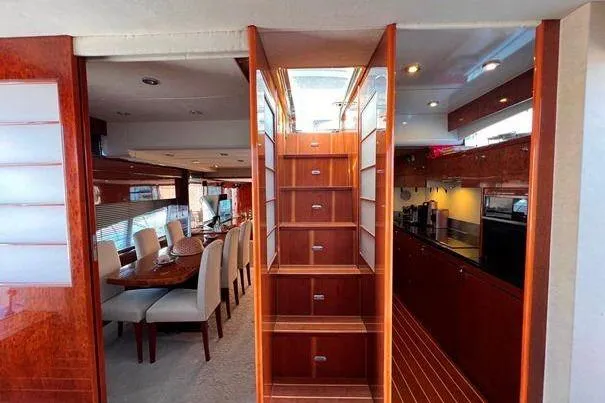  Yacht Photos Pics Luxurious interior of 2004 FAIRLINE SQUADRON 74 yacht with dining area and kitchen.