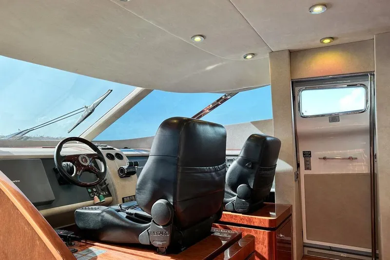  Yacht Photos Pics Interior cockpit of 2004 FAIRLINE SQUADRON 74 yacht with leather seats and steering wheel.