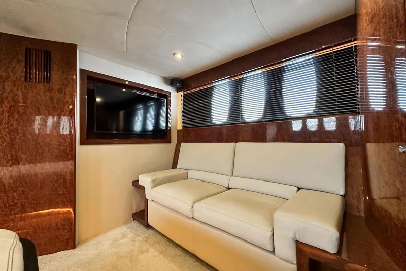  Yacht Photos Pics Luxurious interior of 2004 FAIRLINE SQUADRON 74 yacht with plush sofa and mounted TV.
