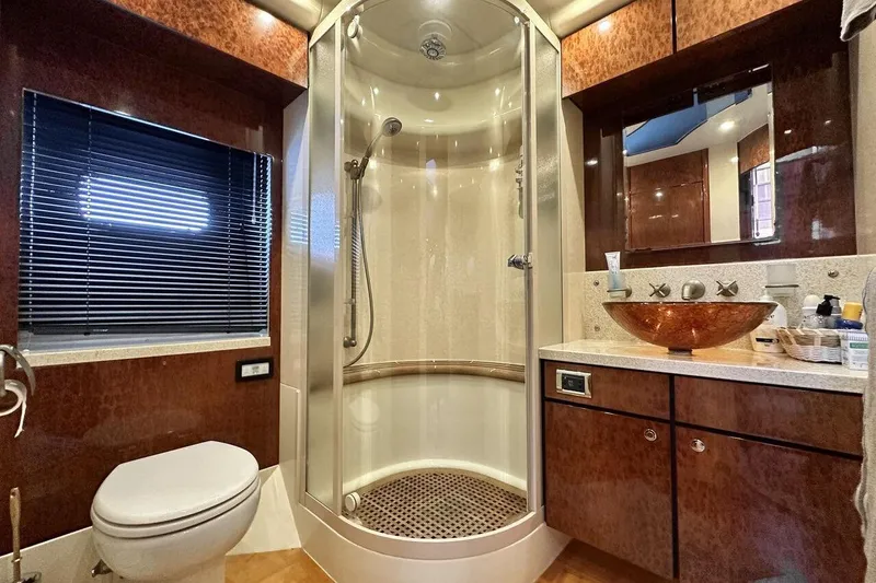  Yacht Photos Pics Luxurious bathroom in 2004 FAIRLINE SQUADRON 74 yacht with modern shower and elegant sink.