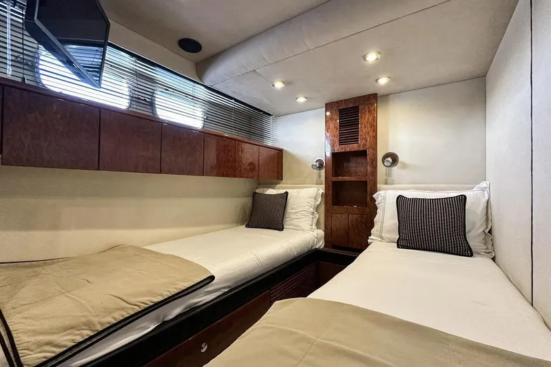  Yacht Photos Pics Luxurious twin cabin interior of 2004 FAIRLINE SQUADRON 74 yacht with modern decor.