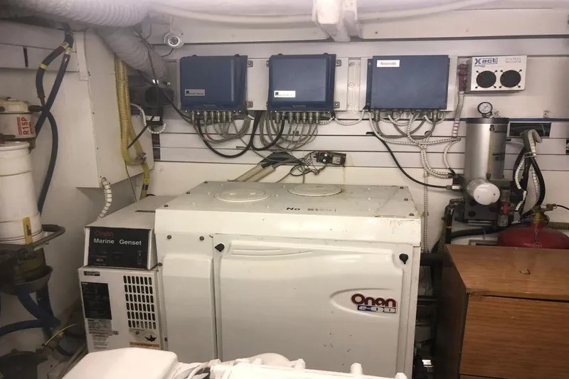  Yacht Photos Pics Engine room of 2004 FAIRLINE SQUADRON 74 with Onan marine generator and control panels.