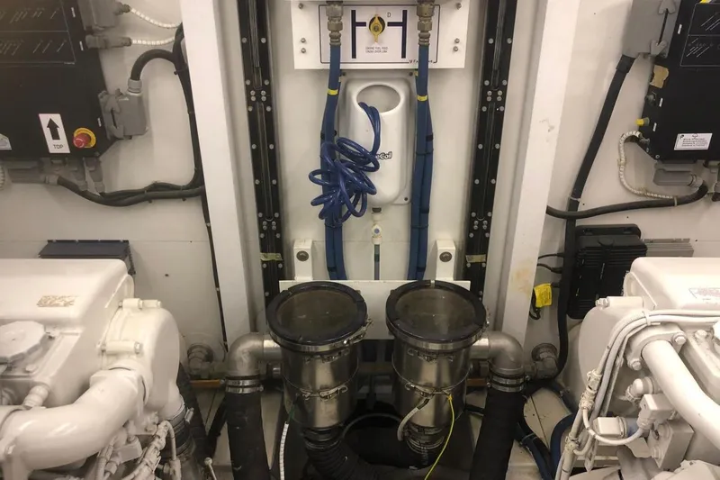  Yacht Photos Pics Engine room of 2004 FAIRLINE SQUADRON 74 yacht, featuring mechanical components and piping.
