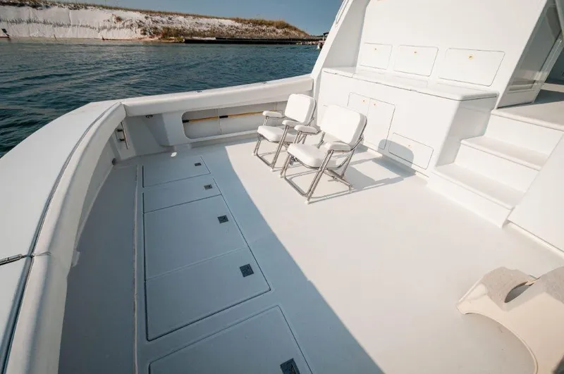 Big Horse Yacht Photos Pics Spacious deck of 2006 Dixon 52 Express yacht with seating, near water.