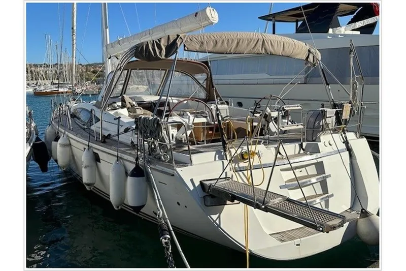  Yacht Photos Pics 2010 Jeanneau 57 yacht docked at marina, featuring spacious deck and modern design.