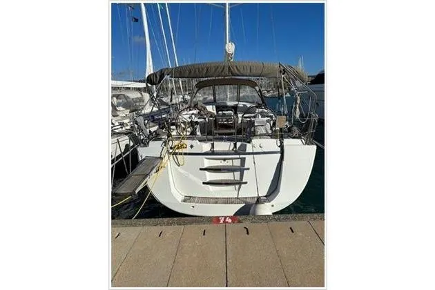  Yacht Photos Pics 2010 Jeanneau 57 yacht docked at marina, rear view with canopy and equipment.