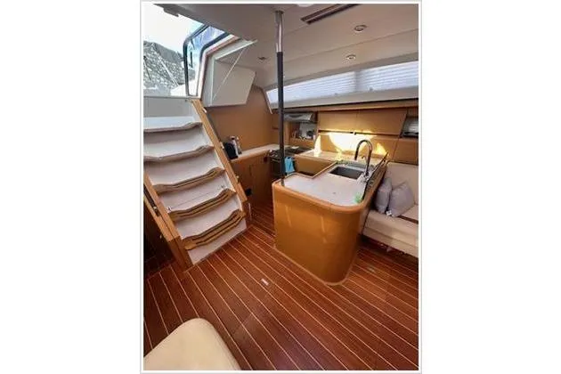  Yacht Photos Pics Interior of 2010 Jeanneau 57 yacht with modern kitchen and wooden flooring.