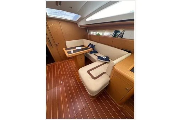  Yacht Photos Pics Luxurious interior of 2010 Jeanneau 57 yacht with elegant seating and wooden flooring.