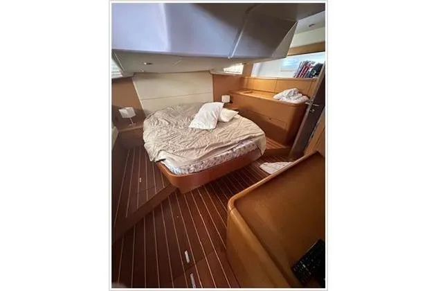  Yacht Photos Pics Luxurious cabin interior of a 2010 Jeanneau 57 yacht with a cozy bed.