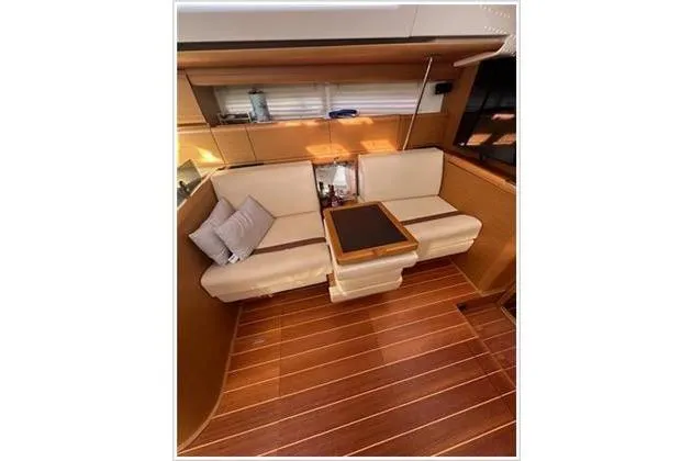  Yacht Photos Pics Luxurious interior of 2010 Jeanneau 57 yacht with elegant seating and wooden flooring.