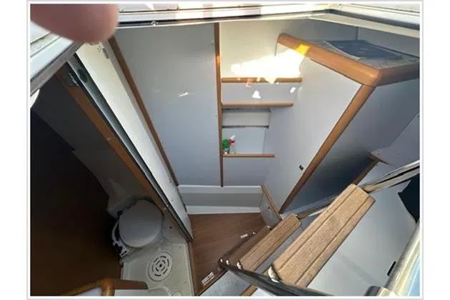  Yacht Photos Pics Interior view of 2010 Jeanneau 57 yacht bathroom with wooden accents and compact design.