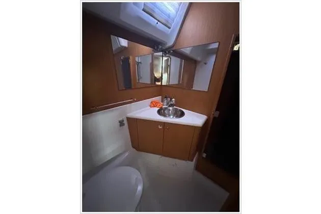  Yacht Photos Pics Bathroom interior of 2010 Jeanneau 57 yacht with sink and mirror.