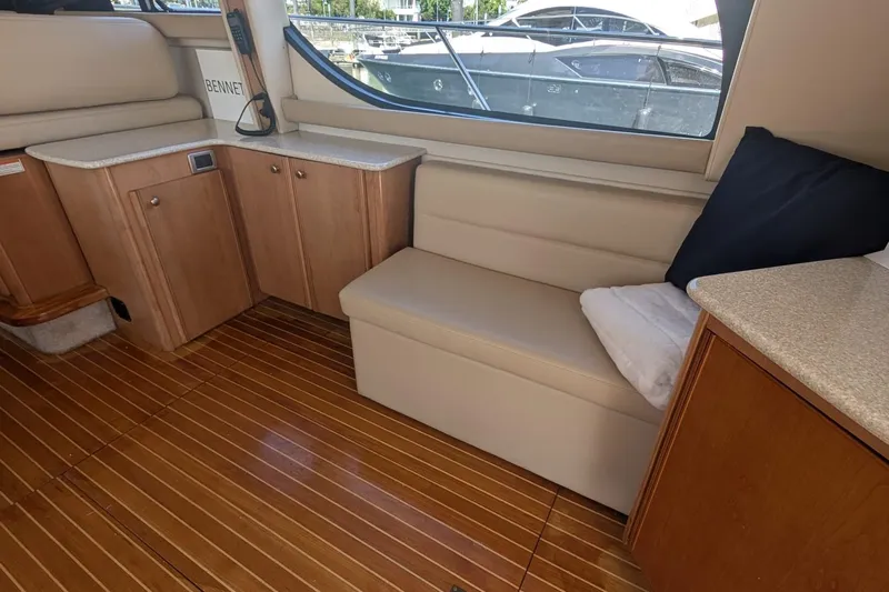 Bennett II Yacht Photos Pics Interior of 2004 Meridian 381 Sedan yacht with wooden flooring and beige seating.