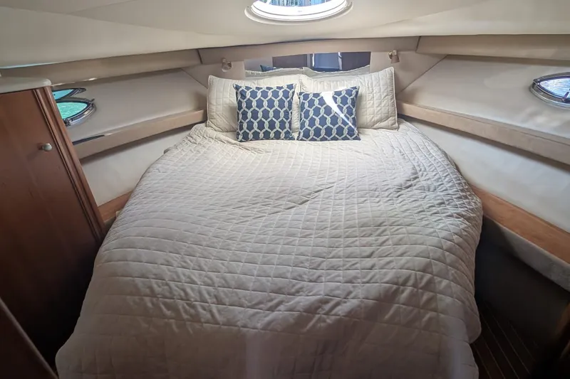 Bennett II Yacht Photos Pics Luxurious cabin interior of 2004 Meridian 381 Sedan with cozy bedding and decorative pillows.