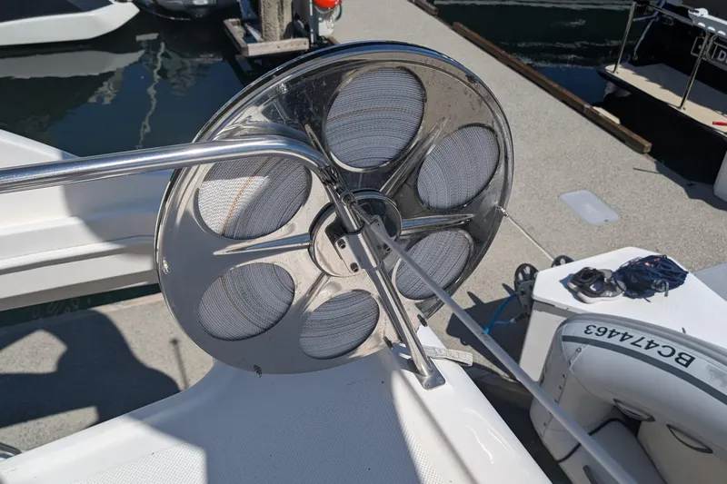 Bennett II Yacht Photos Pics Stainless steel reel on 2004 Meridian 381 Sedan boat deck, docked at marina.