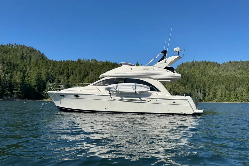 Bennett II Yacht Photos Pics 2004 Meridian 381 Sedan yacht on a serene lake with forested background.
