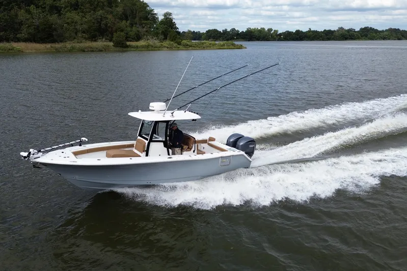  Yacht Photos Pics 2021 Sea Hunt Gamefish 27 Coffin Box cruising on a lake with dual engines.