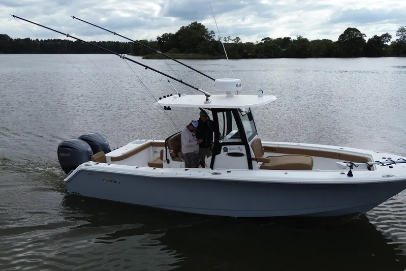  Yacht Photos Pics 2021 Sea Hunt Gamefish 27 Coffin Box boat on a calm lake.