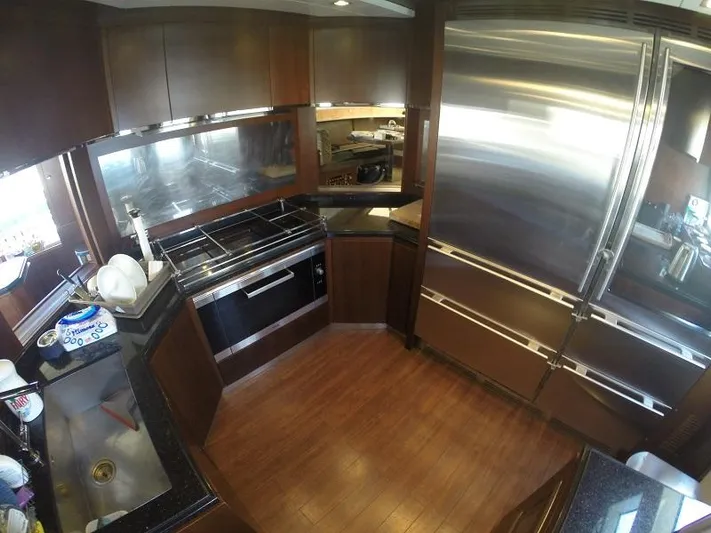  Yacht Photos Pics Luxurious kitchen interior of 2008 Azimut 95 yacht with modern appliances and wood flooring.