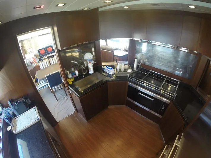  Yacht Photos Pics Luxurious kitchen interior on 2008 Azimut 95 yacht with modern appliances and wood finishes.