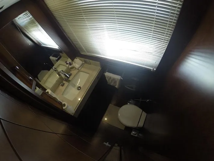  Yacht Photos Pics Luxurious bathroom interior of 2008 Azimut 95 yacht with modern fixtures and wooden accents.