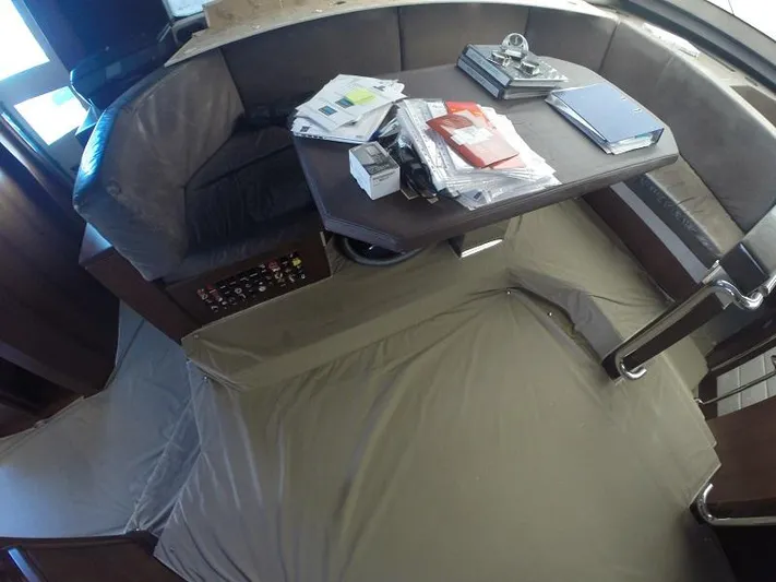  Yacht Photos Pics Interior of 2008 Azimut 95 yacht with table, seating, and documents.