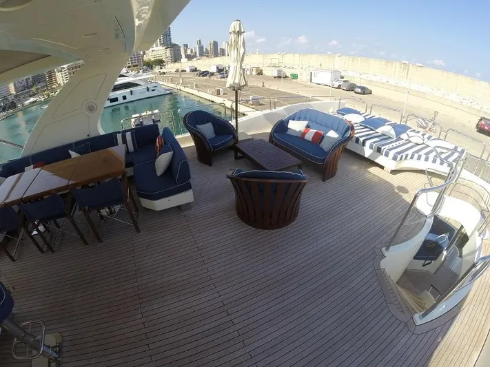  Yacht Photos Pics Luxurious deck of 2008 Azimut 95 yacht with elegant seating and waterfront view.