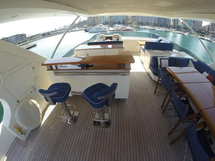  Yacht Photos Pics Luxurious 2008 Azimut 95 yacht deck with seating and bar area, overlooking marina.