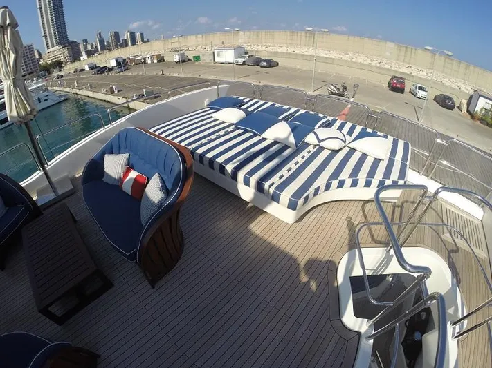  Yacht Photos Pics Luxurious 2008 Azimut 95 yacht deck with striped sunbeds and blue seating, docked at marina.