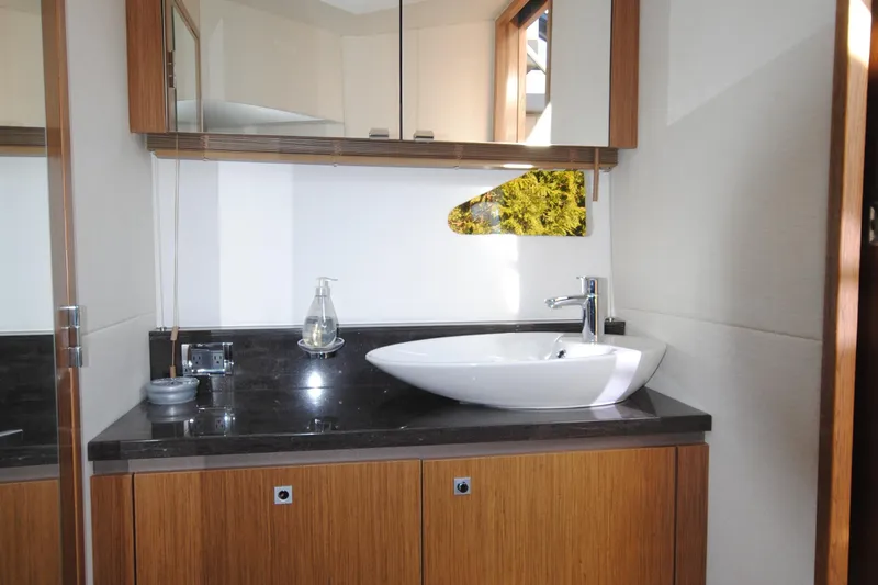  Yacht Photos Pics Luxurious bathroom interior of 2017 Sea Ray Sundancer 510 yacht with modern sink and cabinetry.