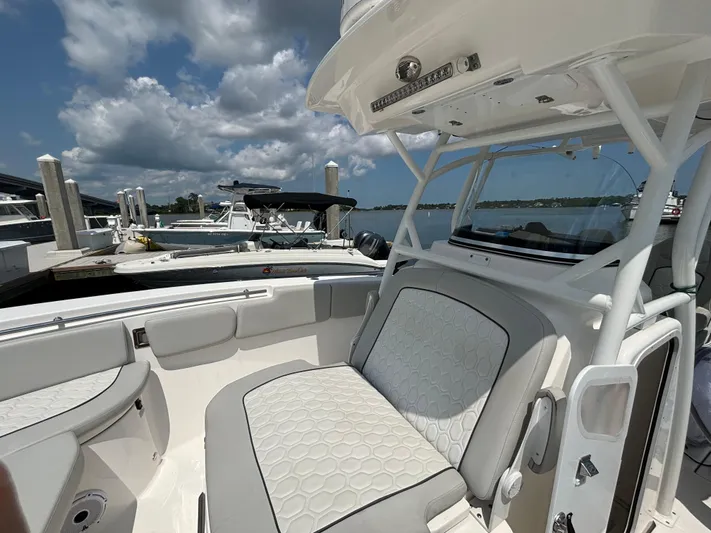 Yacht Photos Pics 2021 Sea Fox 288 Commander boat interior with cushioned seating at a marina.