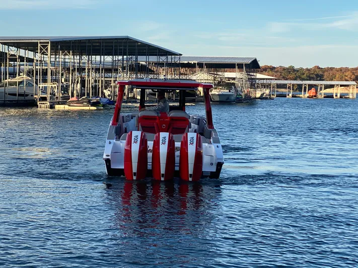  Yacht Photos Pics 2024 Fountain 38 SCX boat with red accents on a lake near a marina.