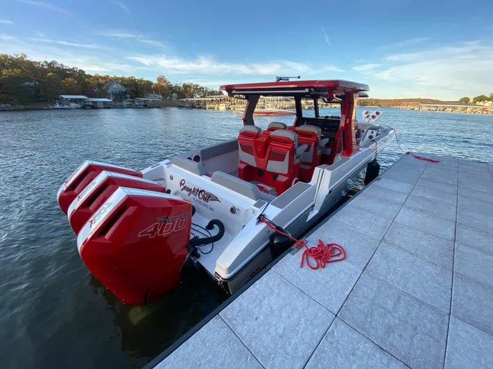  Yacht Photos Pics 2024 Fountain 38 SCX boat docked, featuring triple red outboard engines.