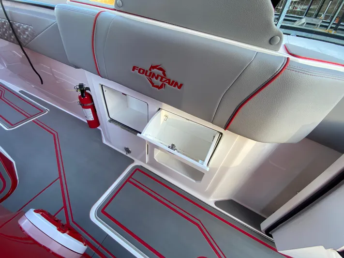  Yacht Photos Pics 2024 Fountain 38 SCX boat interior with storage compartment and fire extinguisher.