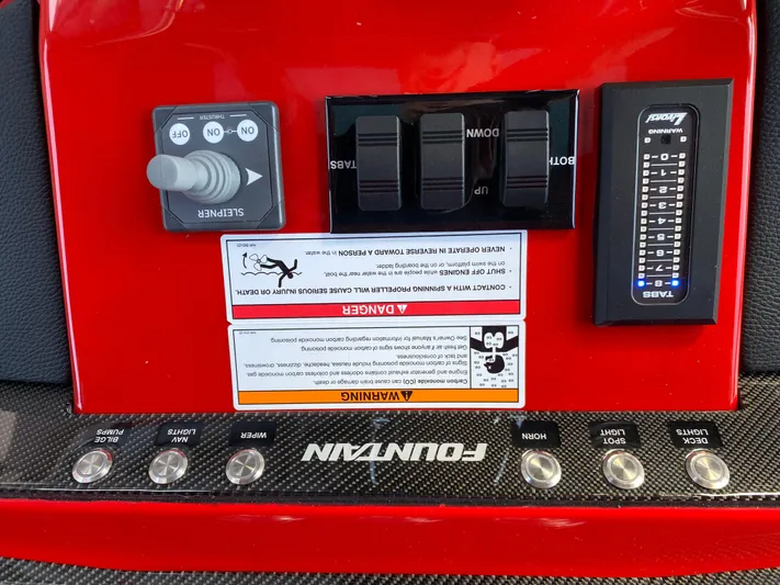  Yacht Photos Pics Control panel of 2024 Fountain 38 SCX boat with switches and warning labels.