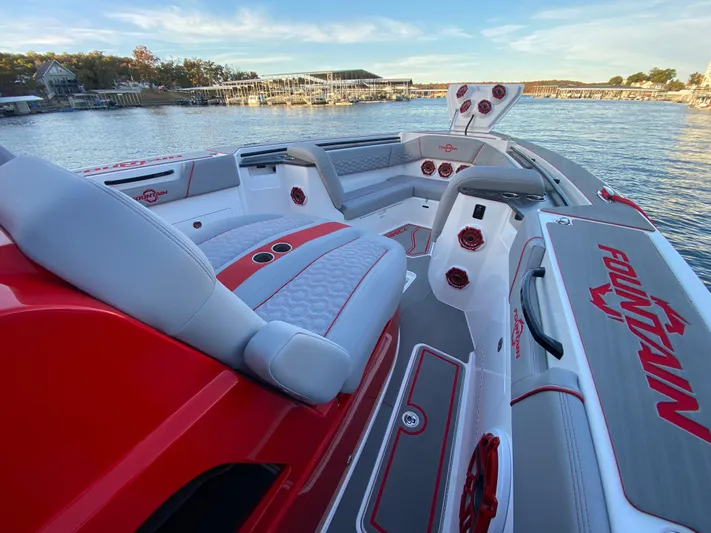  Yacht Photos Pics 2024 Fountain 38 SCX boat interior with red and gray seating, dockside view.