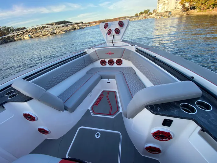  Yacht Photos Pics 2024 Fountain 38 SCX boat interior with gray seating and red accents on a calm lake.