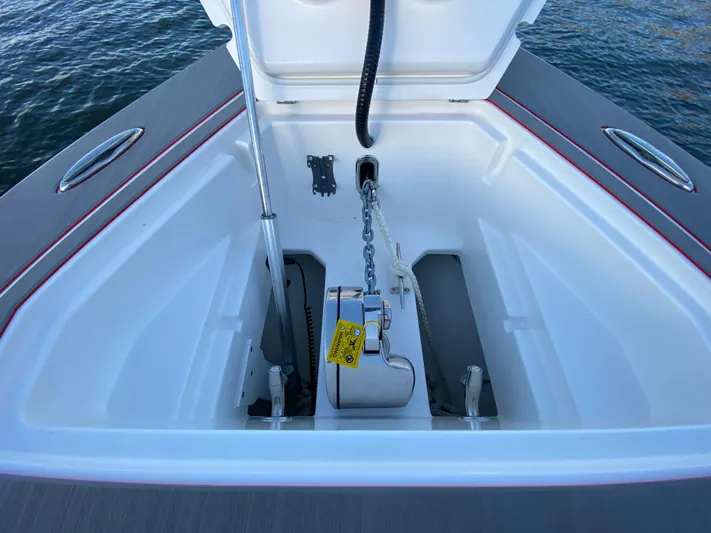  Yacht Photos Pics 2024 Fountain 38 SCX anchor compartment with chain and winch, open on calm water.