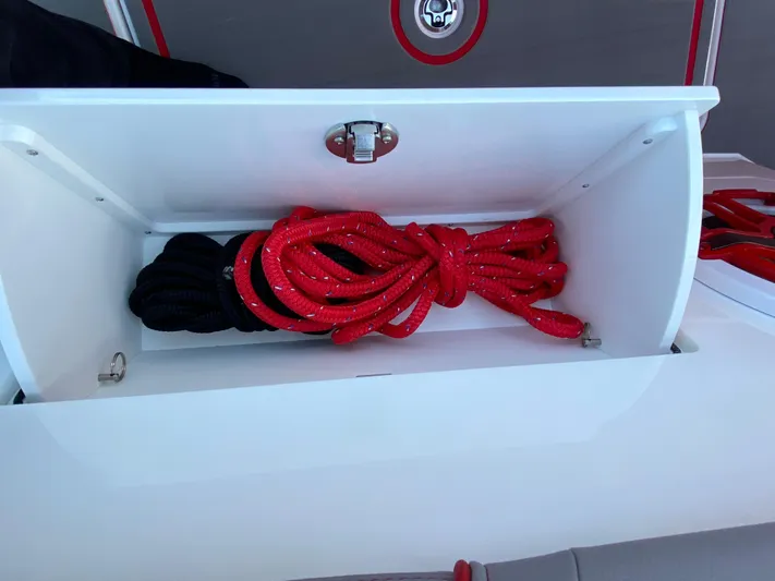  Yacht Photos Pics Storage compartment with red and black ropes on a 2024 Fountain 38 SCX boat.