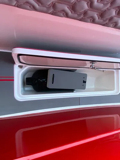  Yacht Photos Pics 2024 Fountain 38 SCX boat storage compartment with a bottle inside.