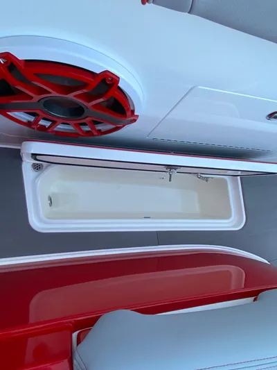  Yacht Photos Pics 2024 Fountain 38 SCX boat interior with red speaker and storage compartment.