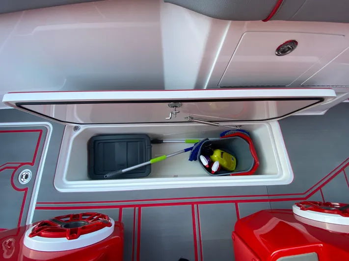  Yacht Photos Pics 2024 Fountain 38 SCX boat storage compartment with cleaning supplies and tools.