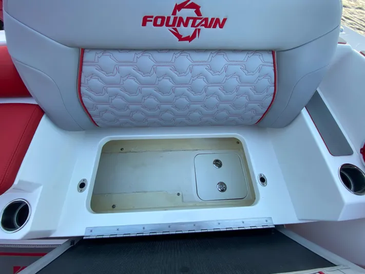  Yacht Photos Pics 2024 Fountain 38 SCX boat seat with storage compartment, white and red design.